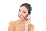 Happy brunette making a call on smartphone