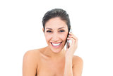 Happy brunette making a call on smartphone smiling at camera