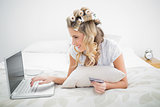 Cheerful cute blonde shopping online using laptop