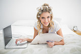 Cheerful natural blonde shopping online using laptop