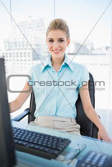 Smiling classy businesswoman posing
