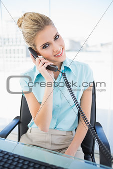 Smiling stylish businesswoman answering the phone