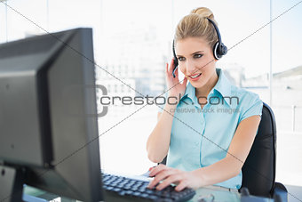 Focused call centre agent working on computer