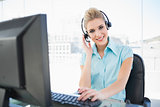 Happy call centre agent working on computer