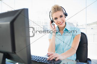 Happy call centre agent working on computer