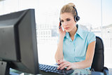 Concentrated call centre agent working on computer
