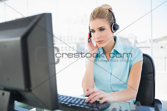 Concentrated call centre agent working on computer