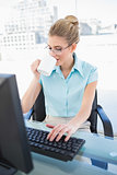 Peaceful elegant businesswoman drinking coffee while working