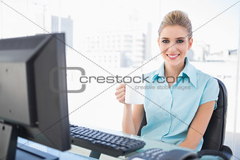 Smiling well dressed businesswoman holding coffee