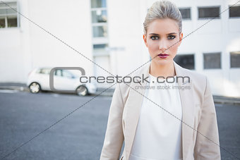 Stern stylish businesswoman posing