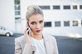 Serious stylish businesswoman having a phone call