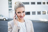 Cheerful stylish businesswoman having a phone call