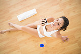 Fit happy woman sending a text during her workout