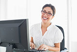Smiling businesswoman working at her desk