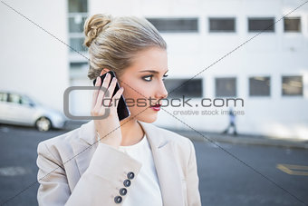 Thoughtful stylish businesswoman having a phone call