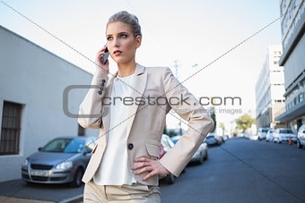 Serious elegant businesswoman on the phone