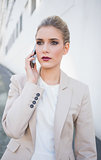 Thoughtful attractive businesswoman on the phone