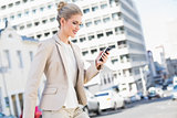 Smiling gorgeous businesswoman text messaging