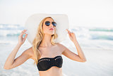 Sexy blonde in elegant bikini wearing straw hat and sunglasses