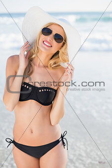 Attractive blonde in elegant black bikini smiling at camera