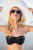 Peaceful sensual blonde in elegant black bikini posing