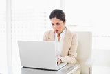 Focused businesswoman working on a laptop
