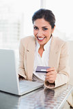 Happy businesswoman shopping online with laptop