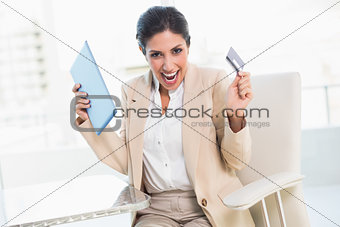 Cheering businesswoman shopping online with tablet pc