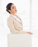 Frowning businesswoman standing behind her chair