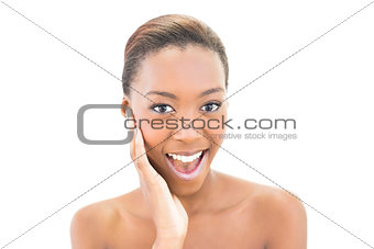 Smiling beautiful model touching her cheek