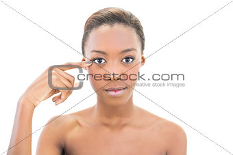 Peaceful natural beauty pointing at wrinkle on her eye