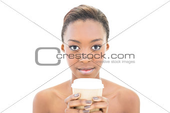 Serious natural beauty holding coffee cup