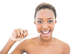 Smiling beautiful model holding toothbrush