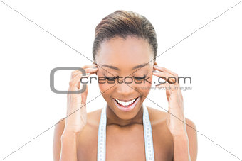Cheerful natural beauty with measuring tape over the neck