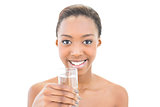 Smiling natural beauty holding water glass