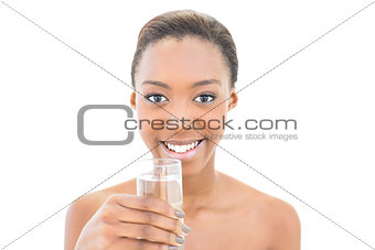 Smiling natural beauty holding water glass