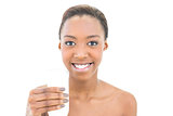 Beautiful smiling model holding glass of milk