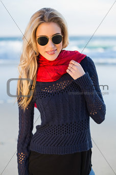 Smiling gorgeous blonde with red scarf posing