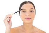 Woman brushing her eyebrow