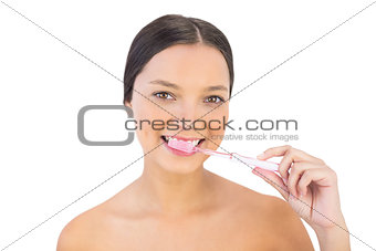 Gorgeous woman brushing her teeth
