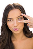 Cheerful woman showing peace sign