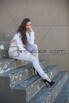 Sexy woman sitting on stairs posing