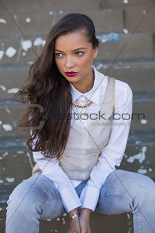 Attractive woman with red lips sitting on stairs