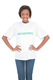 Cheerful woman with hands on hips wearing volunteer tshirt