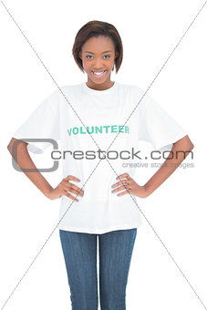 Cheerful woman with hands on hips wearing volunteer tshirt