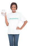 Happy volunteer woman holding glass jar