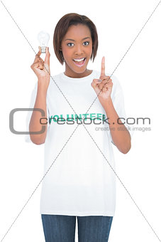 Woman holding light bulb raising the finger up