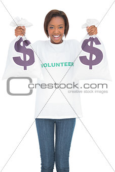 Cheerful woman holding money bags