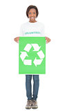 Smiling volunteer woman holding recycling sign