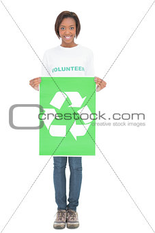 Smiling volunteer woman holding recycling sign